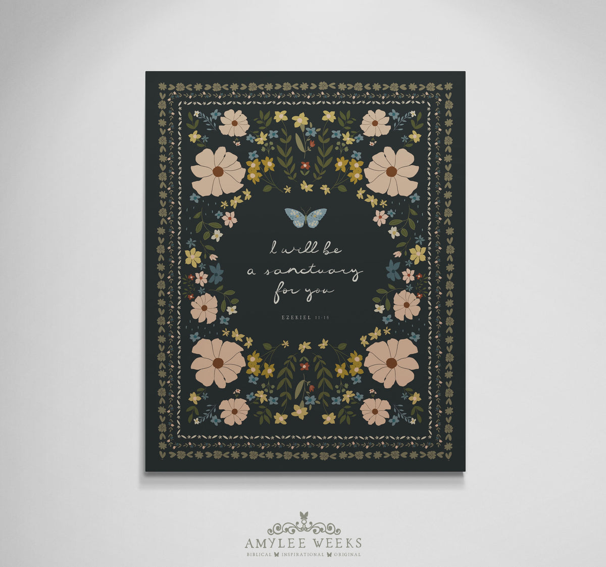 Vertical faith-based typography art titled "I Will Be a Sanctuary" by Amylee Weeks, showcasing stylized cursive scripture framed by botanical gold, blush, and olive green florals over a textured charcoal backdrop.