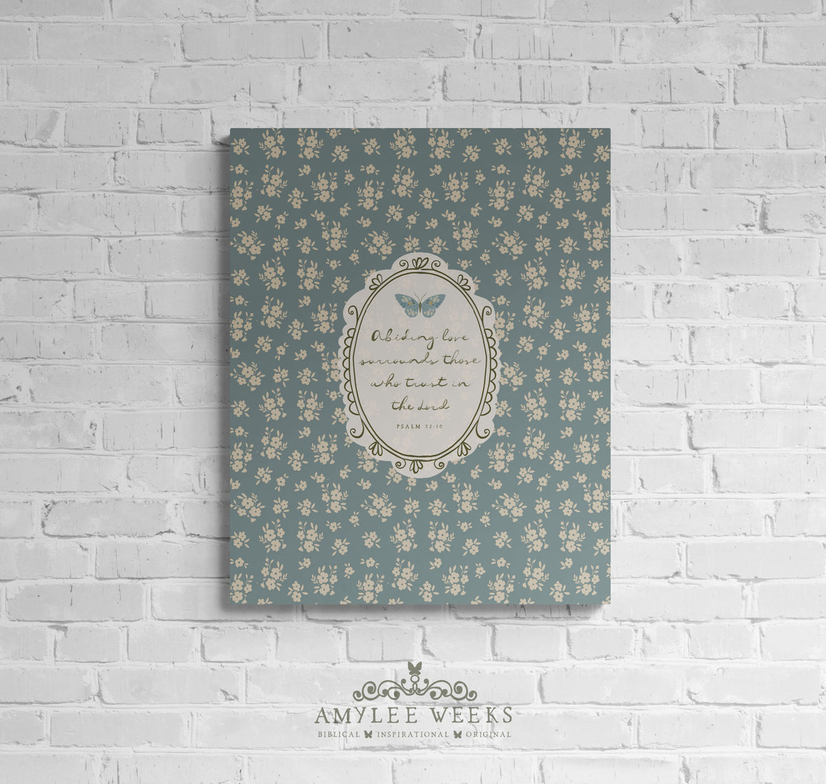 "Abiding Love" Christian wall art by Amylee Weeks, featuring a muted slate-blue background with a central pale blue butterfly and handwritten scripture.